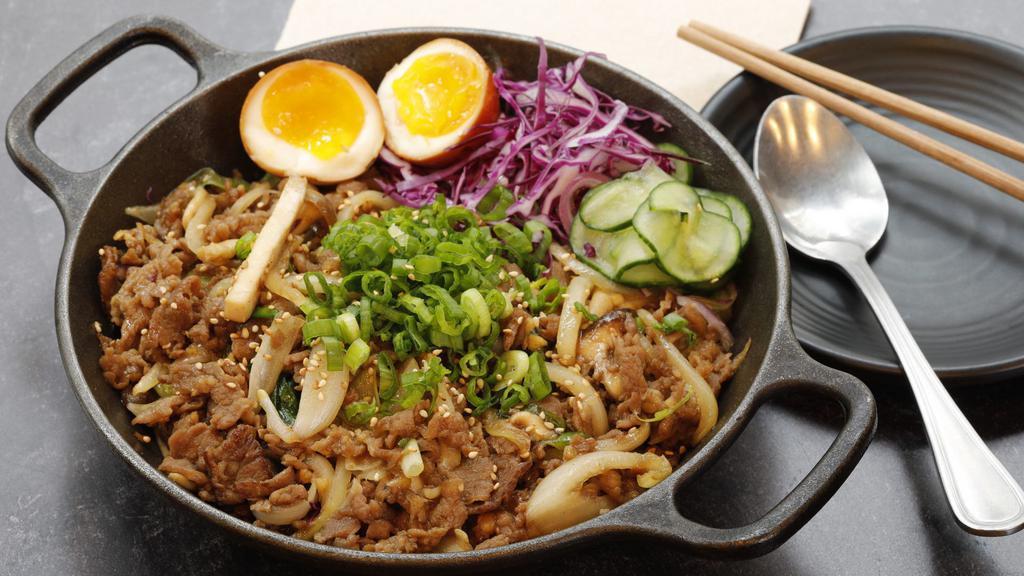 Bulgogi Over Rice / 불고기 덮밥 · Marinated thin sliced rib eye over white rice serve with soft boiled egg.