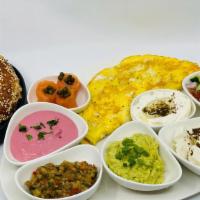 Israeli Breakfast · Eggs served with Israeli salad, smoked salmon, feta cheese, tahini, eggplant spread, kafteri...