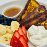 French Toast · Served with fresh berries bananas, whipped cream, and maple syrup.