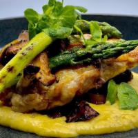Taboon Baked Lemon Herb Chicken Polenta · Served over corn polenta and truffle oil and a selection of sautéed wild mushrooms. GF.