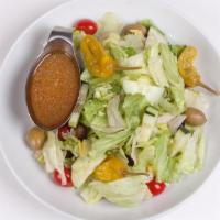 House Salad · Iceberg lettuce, tomatoes, cucumber, olives, pepperoncini, carrots, red cabbage, in our famo...