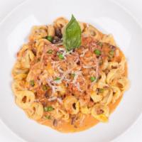 Tortellini Bolognese · Cream sauce with prosciutto di parma dop, onion, mushrooms and peas topped with a touch of m...
