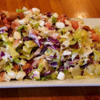 Joe'S Chopped Salad · Romaine red cabbage, tomatoes, white cabbage, candy peanuts and feta cheese chopped fine.