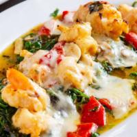 Shrimp Alla Stella · Garlic white wine sauce, roasted peppers and mozzarella, served on a bed of spinach