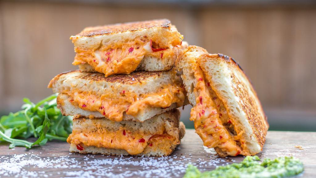 Spicy Grilled Cheese · Pickled jalapeños and Creamy cheese melted between buttery toasted bread.