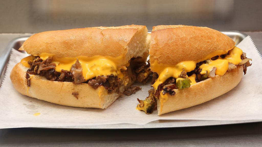 Philly Cheese Steak · Juicy thinly sliced beef steak smothered in a creamy cheese and served between a buttery toasted hero.