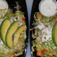 Tacos Dorados (Flautas) · Order of four fried rolled tacos stuffed with chicken and potatoes. Topped with lettuce, tom...