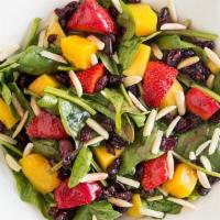 Tropical Salad · Mango, strawberries, almonds, craisins, over baby spinach, served with a raspberry vinaigret...
