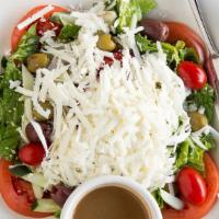 Greek Salad · Hearts of romaine, tomatoes, cucumber, red onion, olives with shredded feta cheese served wi...