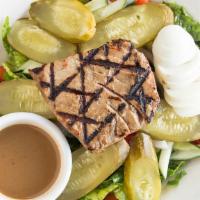 Tuna Nicoise Salad · Grilled tuna, olives, hard boiled eggs, tomatoes, and pickles served with vinaigrette on a b...
