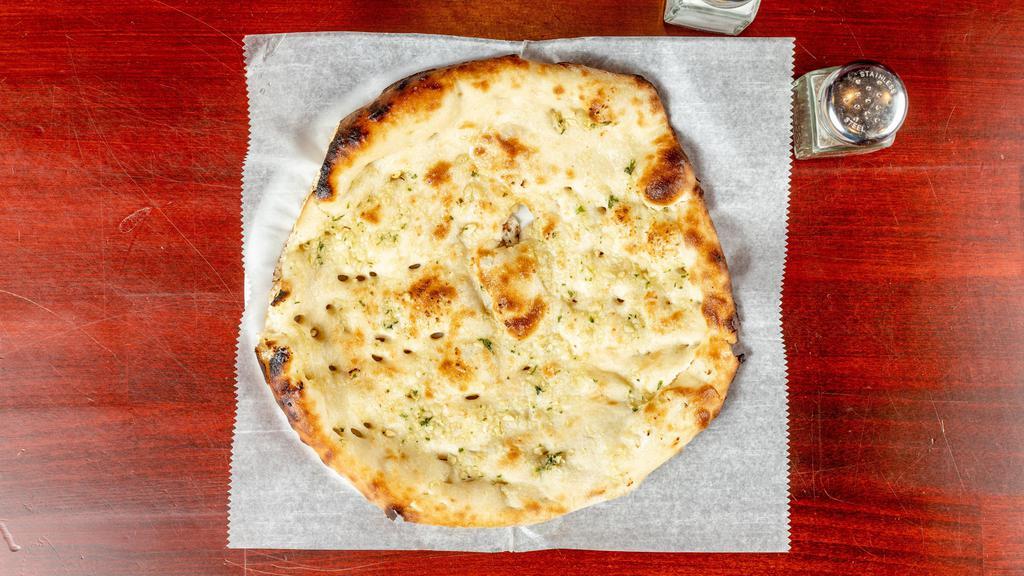 Garlic Naan · Teardrop shaped white bread with a touch of garlic.