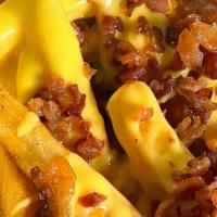 Bacon And Beyond Fries  · Idaho potato fries cooked until golden brown and garnished with salt, melted cheddar cheese,...