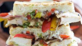 Chicken Fajita Panini · Grilled chicken breast, cheddar, roasted peppers, caramelized onions and salsa. Served with ...