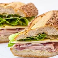 Ham & Cheese · Heritage ham, Cabot cheddar, romaine, onion, and pickle dijonaise on Caputo's seeded club ro...
