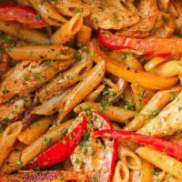 Chicken Rasta Pasta · Creamy penne pasta with sautéed onions, peppers, carrots, garlic, ginger, cilantro, penne pa...