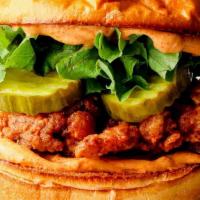Hot Honey Crispy Chicken Sandwich · lettuce, tomato, pickles, onion jam, cilantro-lime plant based spicy mayo