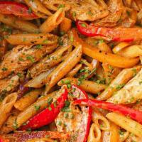 Salmon Rasta Pasta · Creamy penne pasta with sautéed onions, peppers, carrots, garlic, ginger, cilantro, penne pa...