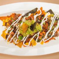 Fully Loaded Nachos · Warm nachos topped with salsa, guacamole, sour cream, and cheese.