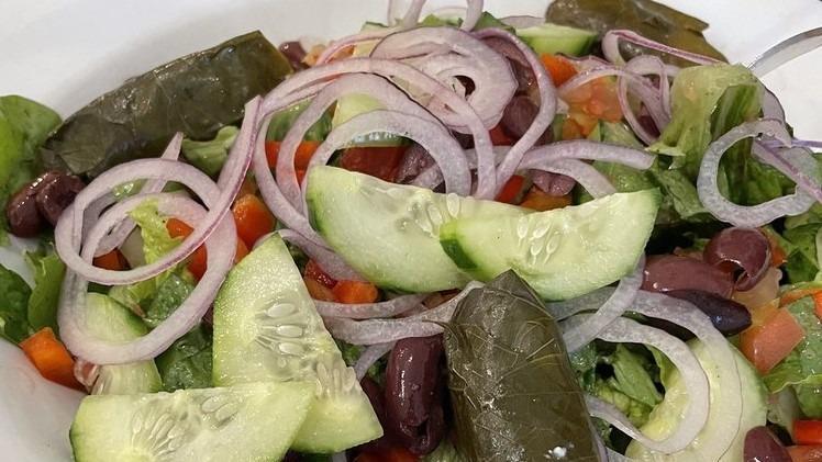 Chopped Greek Salad · Romaine lettuce, cucumbers, red onions, tomato, kalamata olives, grape leaves, green peppers, feta cheese in a red wine vinaigrette dressing.