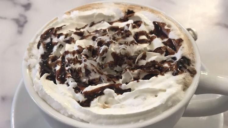 Almond Joy Latte · Steamed milk blended with espresso, coconut and chocolate sauce, topped with whipped cream and coconut flakes.