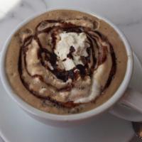 Caffe Mocha · Steamed milk mixed with espresso and belgian chocolate sauce, topped with whipped cream.