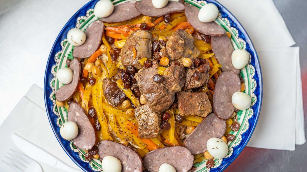 Samarkand Plov · Uzbek plov -  cooked with rice, fresh beef, yellow and red carrot, onions and vegetable oil. Traditionally, our Uzbek plov is prepared in a deep cast-iron pot (kazan), which is uniformly warmed and a dish is not burnt.