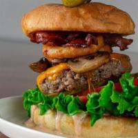 Burger Bomb, Toasted Bulkie Roll · Leaf lettuce, tomato, bacon, sliced pickles, fried onion rings, sautéed mushroom cheddar che...