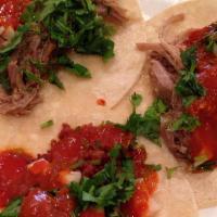 The Twin Tacos · Order of two. One soft corn tortilla and one hard shell stuck together with refried beans se...