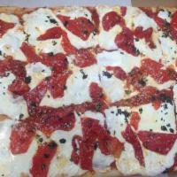 Sicilian Pizza · Thin crust pizza with tomato sauce, mozzarella and basil.