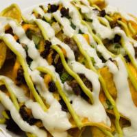 Nachos Supreme · Fresh tortilla chips topped with your choice of meat, beans, sour cream, avocado crema, cila...