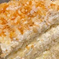 Toasted Coconut Custard Cake · Coconut with blanched almonds.  Finished with vanilla frosting, toasted coconut and almonds.