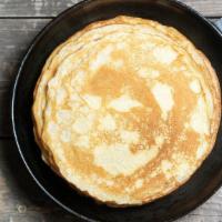 Pancakes · Three fluffy and delicious pancakes. Served with one syrup container.