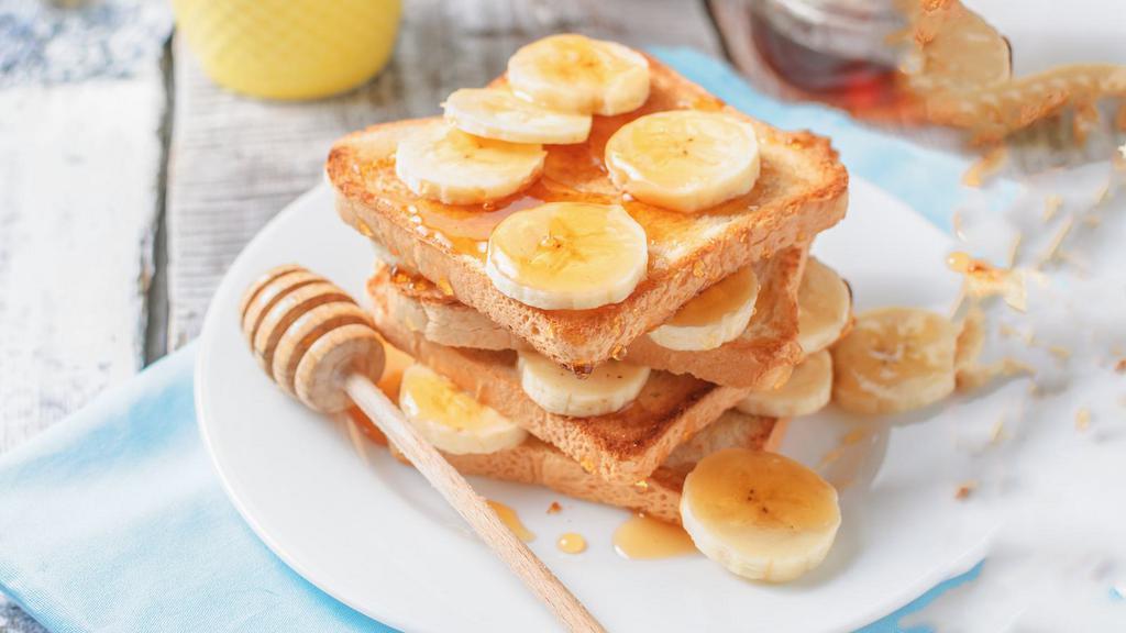 Banana French Toast · French toast served with banana slices and syrup.
