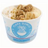 Nutcracker Oatmeal Bowl · steel cut oatmeal with brown sugar topped with banana, sliced almonds, walnuts,  coconut fla...