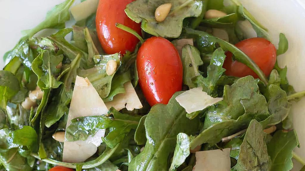 Rughetta Salad · Baby arugula cherry tomatoes vegan parmesan evoo and lemon juice.