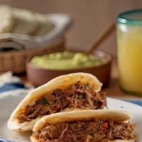 Ropa Vieja  Arepa · Cuban Style Shredded Beef  inside of a Gluten free and Fat free baked Flatbread made of grou...