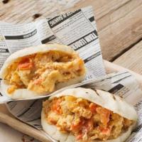 Perico Arepa · Sauteed Peppers & Onions infused with scrambled eggs inside of a Gluten free and Fat free ba...