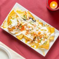 Locos Nachos · Dairy. Beans, cheese, jalapeños, crema, pico de gallo & green onions. Protein Addition for a...