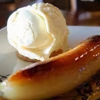 Banana Flamiada · Sauteed banana topped with vanilla ice cream served flambeed then topped with cinnamon and w...