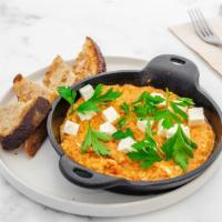 Persian Shakshuka · House-made garlic tomato sauce, baked with eggs, topped with fresh herbs and feta cheese, se...