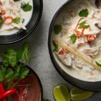 Tom Kha Noodle Soup · Rich, creamy, tangy, and spicy. Spicy coconut broth with made with choice of noodles, tomato...