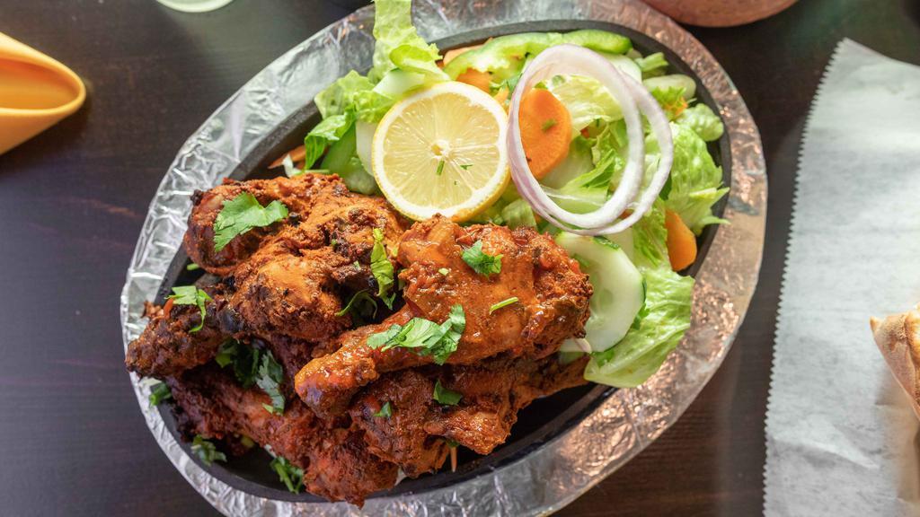 Tandoori Chicken · Spring chicken marinated in freshly ground spices.