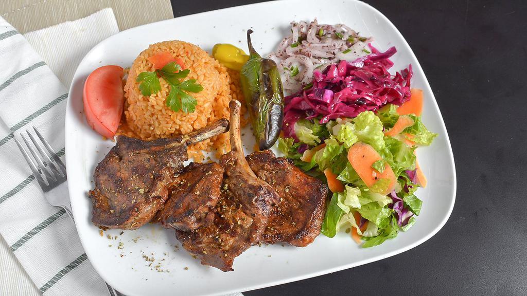 Lamb Chops · For pieces of grilled baby lamb chops served with rice and salad.
