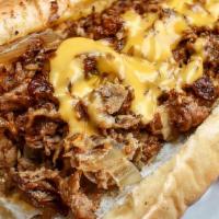 Philly (Large) · Shaved steak, caramelized onions and cheese sauce on a seasoned tunnel roll.