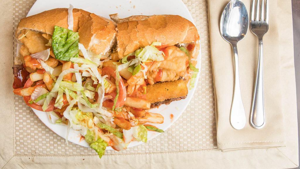 Fat Beach Sandwich · Cheese steak, chicken fingers, mozzarella sticks, French fries, mayonnaise, ketchup, lettuce, and tomatoes.