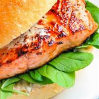 Salmon Burger Specialty · 10 oz center-cut salmon fillet, tomato, romaine lettuce, caramelized onion, tartar sauce ser...