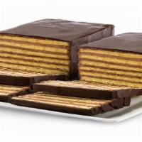 7 Layer Cake · Seven thin layers of a yellow sponge cake stacked in between thin layers of  chocolate butte...