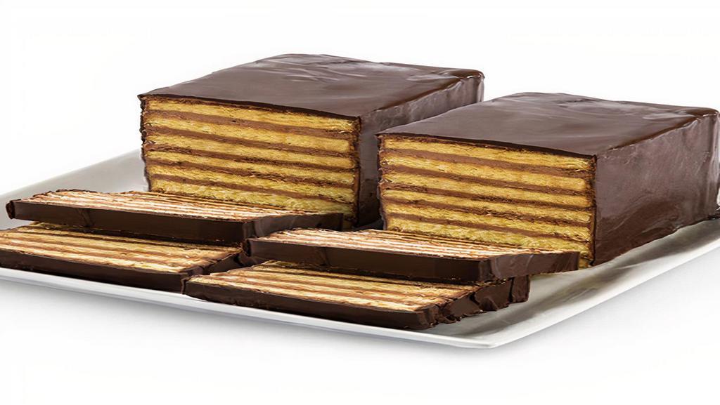 7 Layer Cake · Seven thin layers of a yellow sponge cake stacked in between thin layers of  chocolate buttercream, and then  covered in chocolate ganache.  About 4-6 servings.