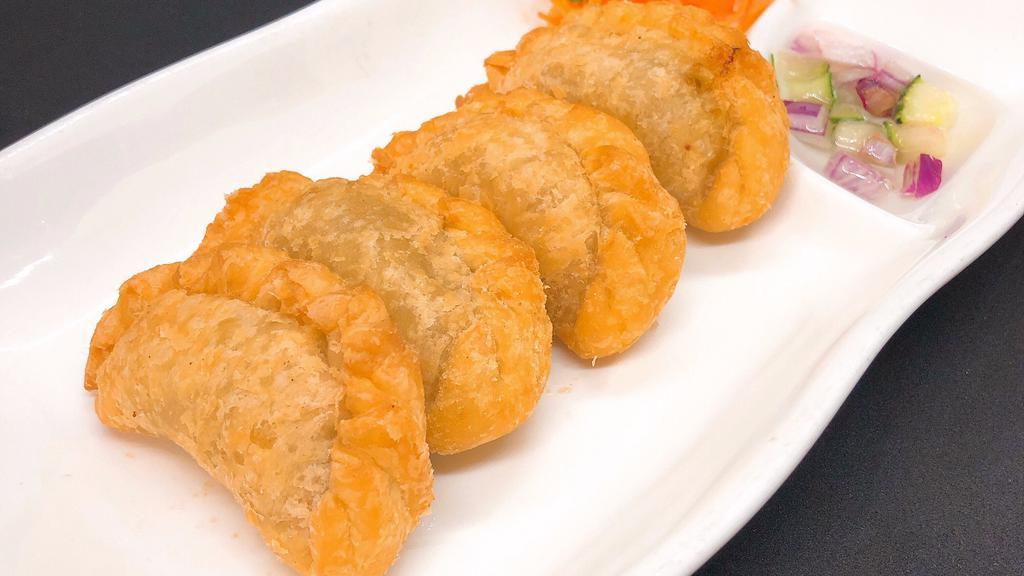 Chicken Curry Puffs · Pastry puff with ground chicken, potatoes, onion with cucumber sauce.