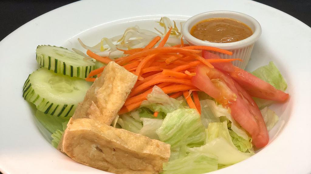 Green Thai Salad · Mixed green, lettuce, tomatoes, tofu, cucumbers  and bean sprouts  with peanut dressing.